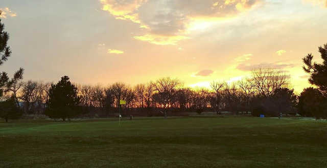 A sunset view of a green at Riverview Country Club.