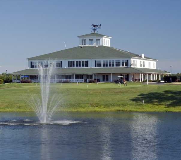 A view of the clubhouse and putting green at Little River Golf & Resort