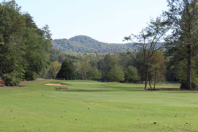 A view of a hole with mountains in the distance at The Rock Golf Club & Resort.