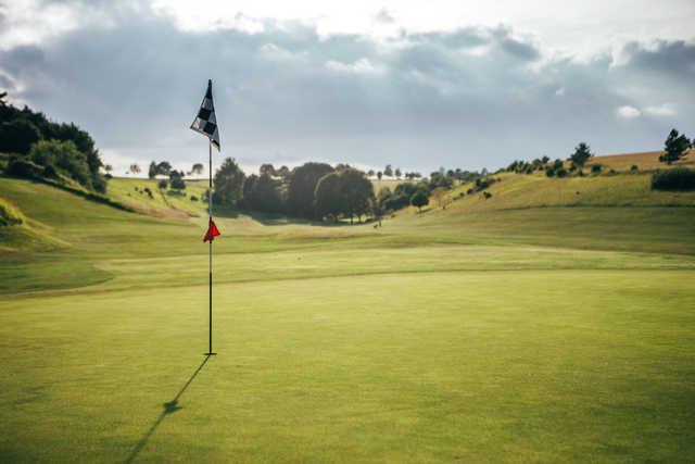 A sunny day view of a hole at Cirencester Golf Club.