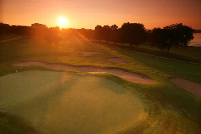 A splendid sunset view of a green from Majestic Oaks at Lake Lawn Resort.