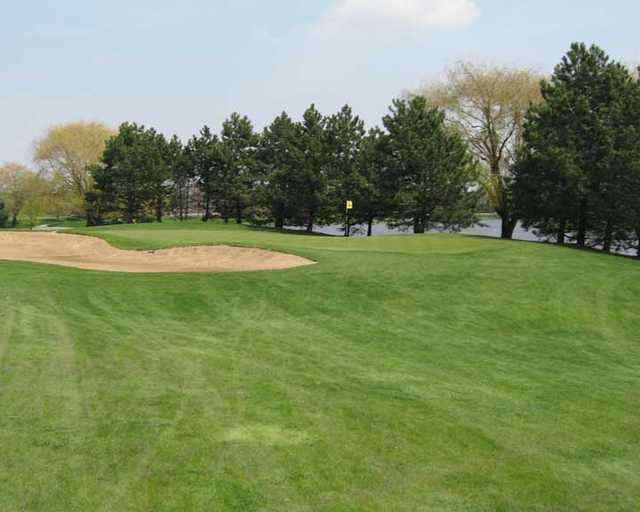 A view of a hole guarded by a bunker at Walnut Greens Golf Course.