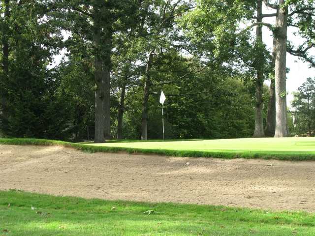 A sunny day view of a hole at Greenshire Golf Course.