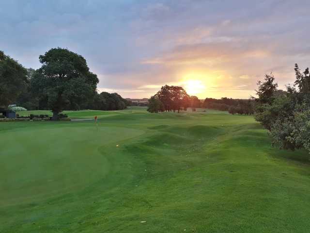 A sunset view of a green at Kenwick Park Golf Club.