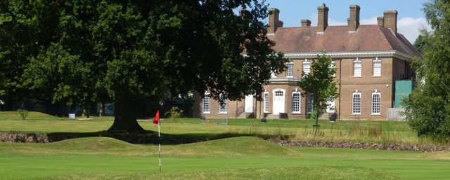 A view of a green and the clubhouse at Batchwood Hall Golf Club.