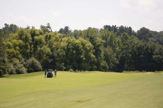 A sunny day view of a fairway at Fairway Hills Golf Club.