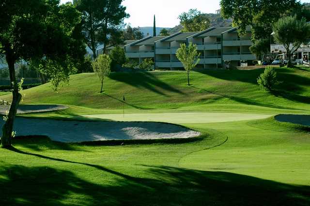 A sunny day view of a hole at San Vicente Golf Resort.