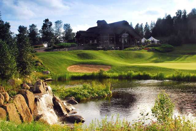 A sunny day view of a green at Le Maitre de Mont-Tremblant.