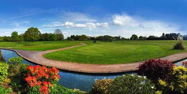 A sunny day view of a green at High Legh Park Golf Club.