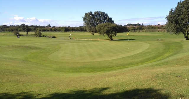 A sunny day view of a green at Poulton le Fylde Golf Club.