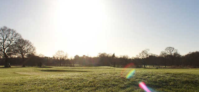 A sunny day view of a green at 9-hole Academy Course from Styal Golf Club.