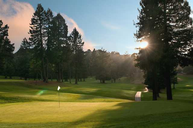 A sunny view of a hole at Tilden Park Golf Course.