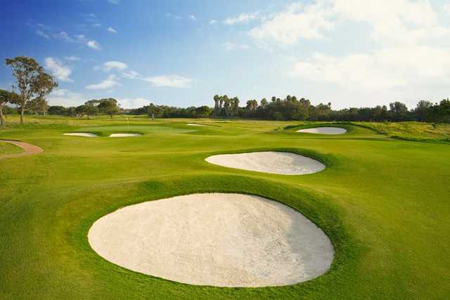 A view of a hole surrounded by tricky bunkers at Olivas Links Golf Course.