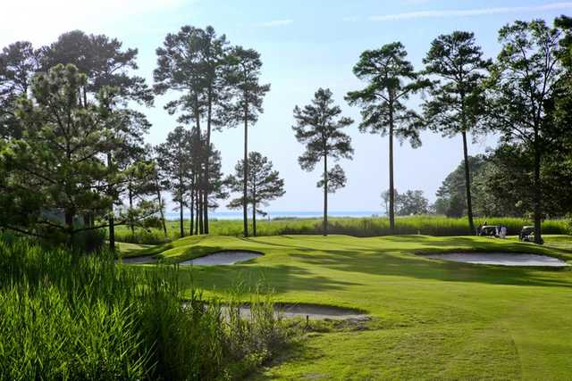 A view of a green protected by bunkers at Swan Point Yacht & Country Club