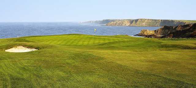A view of a green with water in background at Scarborough South Cliff Golf Club.