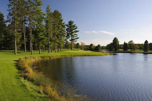 The sixth hole on the Reflections Course at Garland Lodge & Resort is bordered by a large pond to the right with bunkers protecting the right front and back of the green.