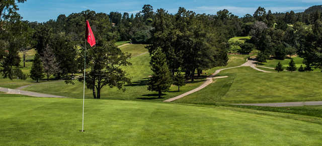 A sunny day view of a hole at Lake Chabot Golf Course.