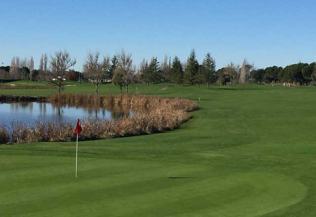 A sunny day view of a hole at Rooster Run Golf Club.