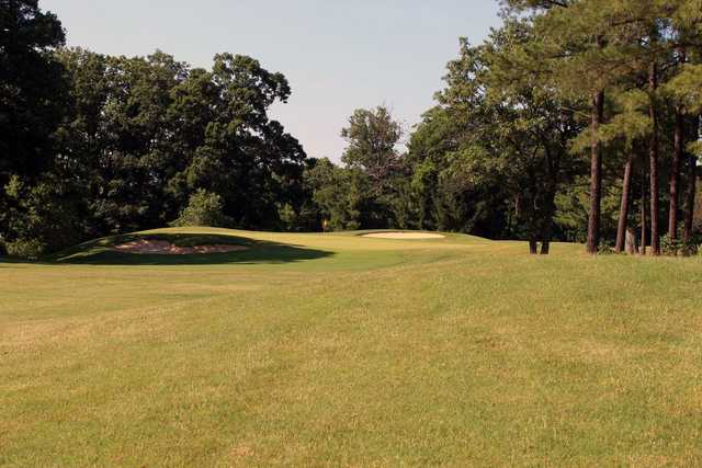 A view of a green flanked by sand traps at Fort Belvoir Golf Club.