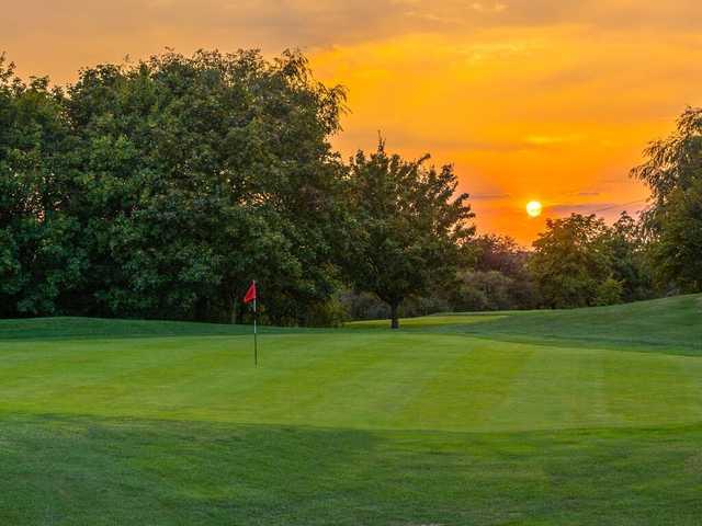 Sunset view of a green at Mowsbury Golf Club