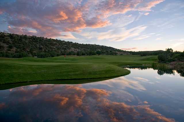 A sunset view of a green at Pinon Hills Golf Course.