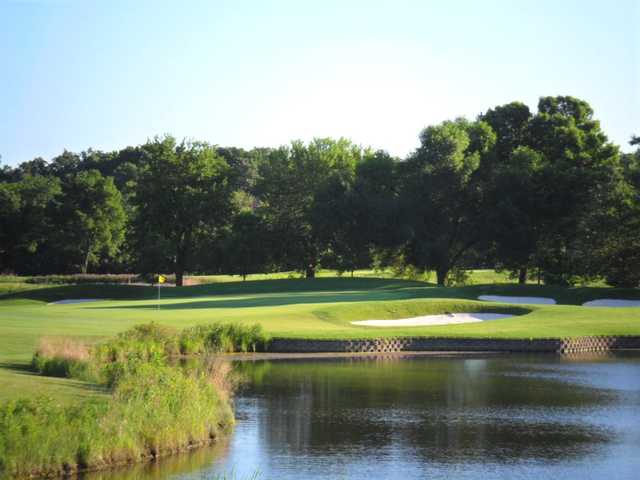 A sunny day view of a hole at Arrowhead Golf Club.