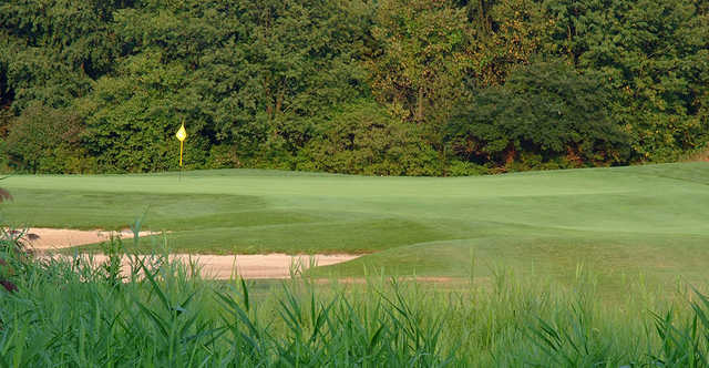 A sunny day view of a green at The Sanctuary Golf Club.