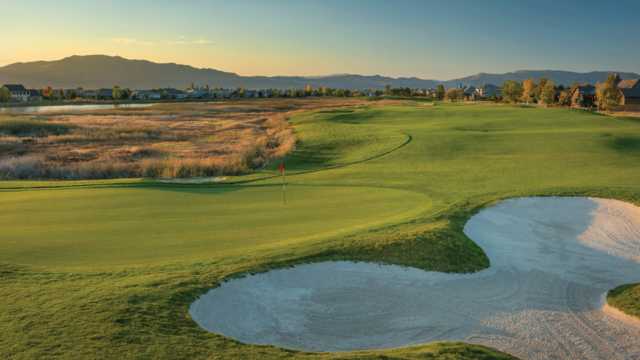 A view of a green guarded by a tricky bunker from Lakes Course at Red Hawk.