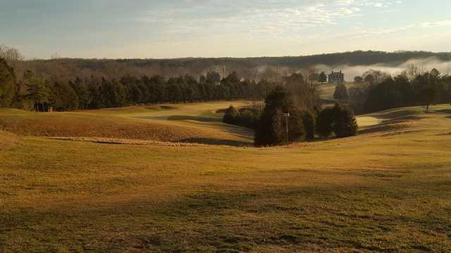A sunset view of a hole at Somerset Farms Golf Course.