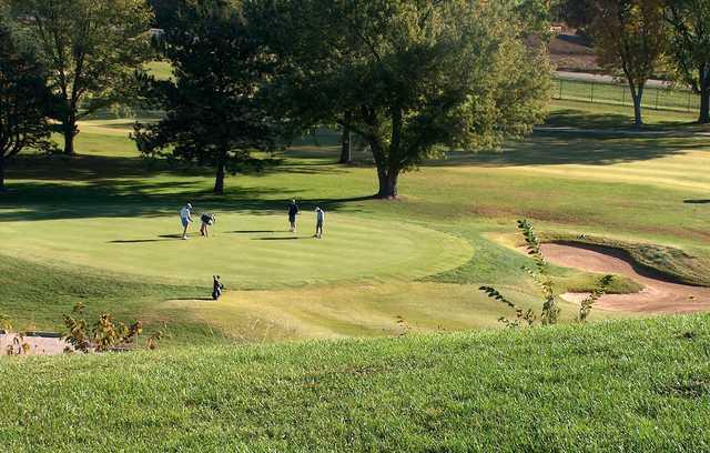 A sunny day view of a green at Lake Shawnee Golf Course.