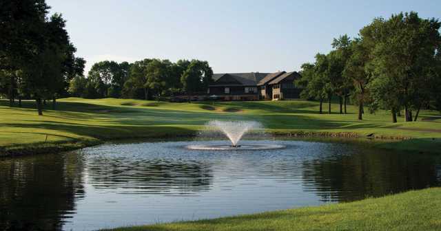 A view over a pond of the clubhouse at Mendakota Country Club.
