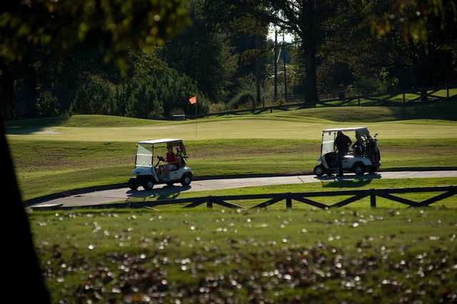 A sunny day view of a hole at Chimney Oaks Golf Club.