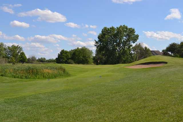 A sunny day view of a hole at Mill Creek Golf Club.