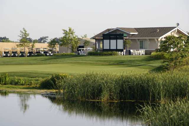 A sunny day view of a green at Wild Wings Golf Club.