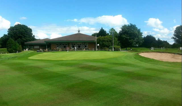 A view of a green and the clubhouse at Wrexham Golf Club.