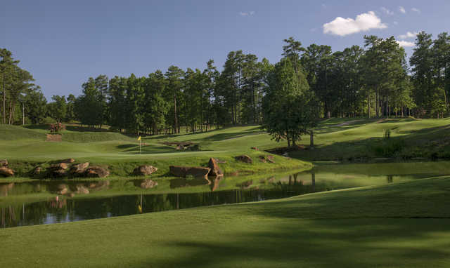 A view of a green surrounded by water at Legacy Golf Links.
