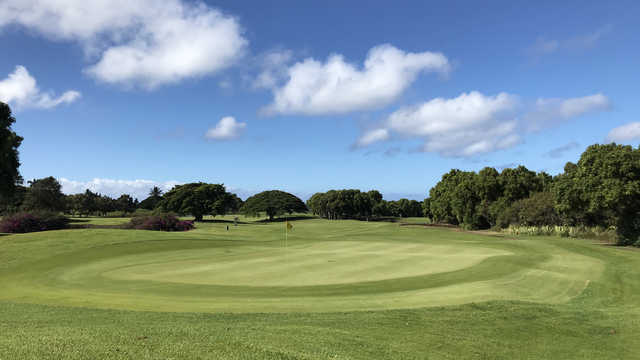 A sunny day view of a green at Kiahuna Golf Club.