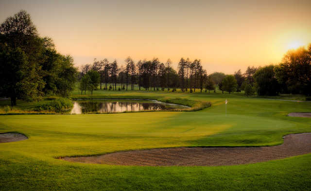 A sunset view of a hole at Pine Meadow Golf Club.