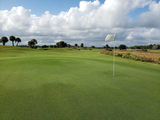 A sunny day view of a hole at Indian River Preserve Golf Club.