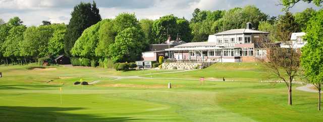 A view of two greens and the clubhouse at Northwood Golf Club.