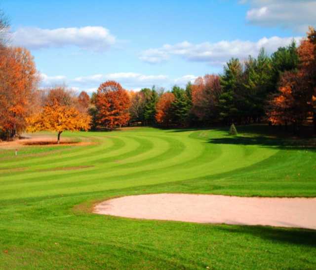 A fall view of a fairway with a bunker on the right at Oakhurst Country Club