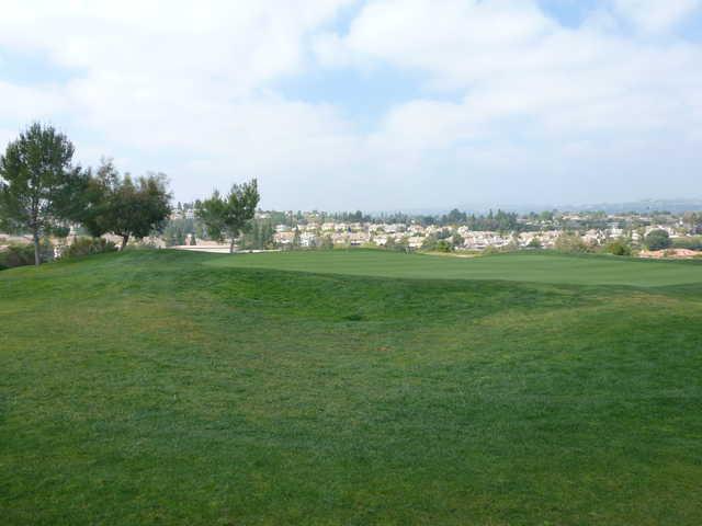 A view of a green with houses in the distance at Westridge Golf Club.