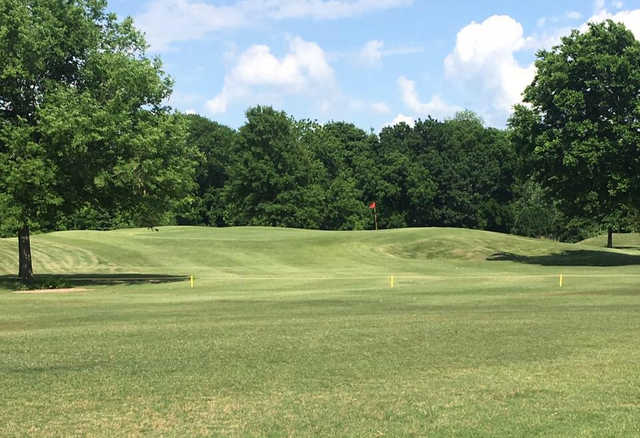 A sunny day view of a hole at Sapulpa Golf Course.