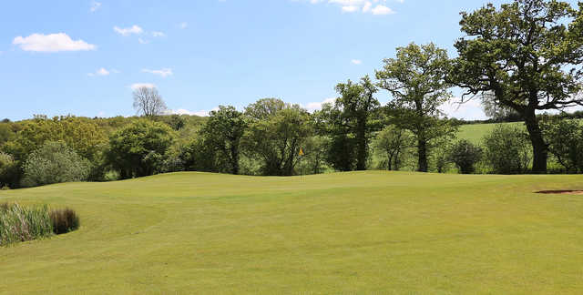 A sunny day view of a hole at Magnolia Park Golf & Country Club.