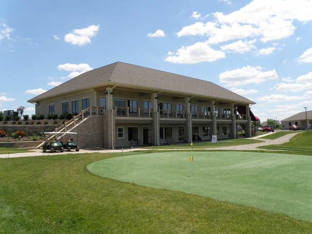 A view of the clubhouse with putting green in foreground at Little Bear Golf Club