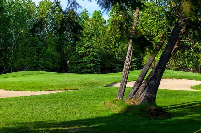 A sunny day view of a hole at Charlevoix Golf & Country Club.