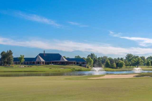 A sunny day view from a fairway with the clubhouse in background at Walnut Creek Country Club.