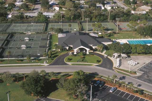 A view of the clubhouse surrounded by tennis courts and swimming pool on the right at Bardmoor Golf & Tennis Club.