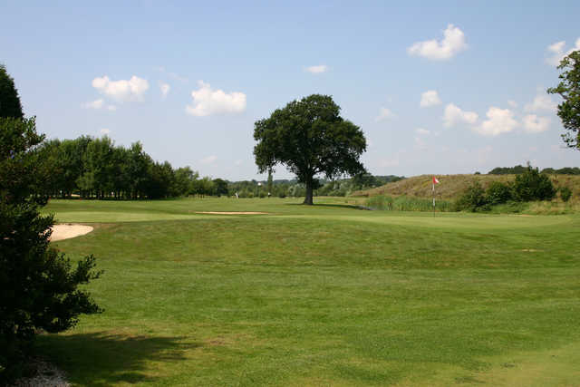 A sunny day view of a hole at Kent & Surrey Golf & Country Club.