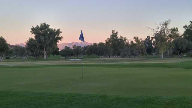 A sunset view of a green from Tres Rios Golf Course at Estrella Mountain Park.